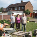 Tom and his parents nearing the end of brick laying