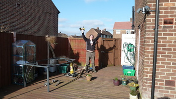 Tom celebrates fixing the hole in the decking
