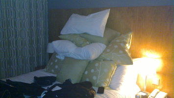 Hotel room has a few too many pillows